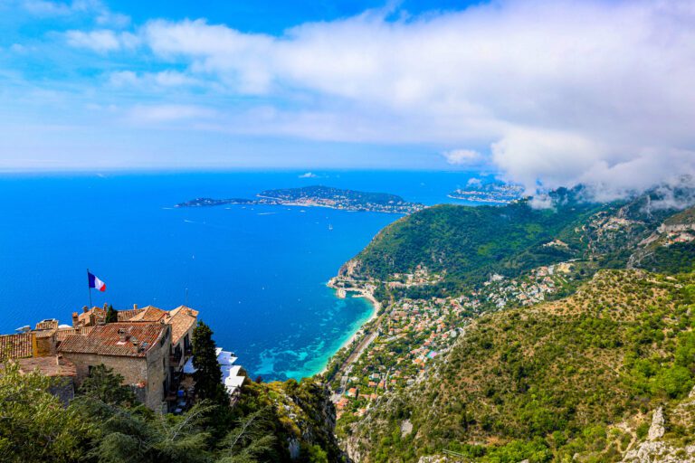 Beautiful garden in Eze, France, with lush greenery, colorful flowers, and a view of the Mediterranean Sea
