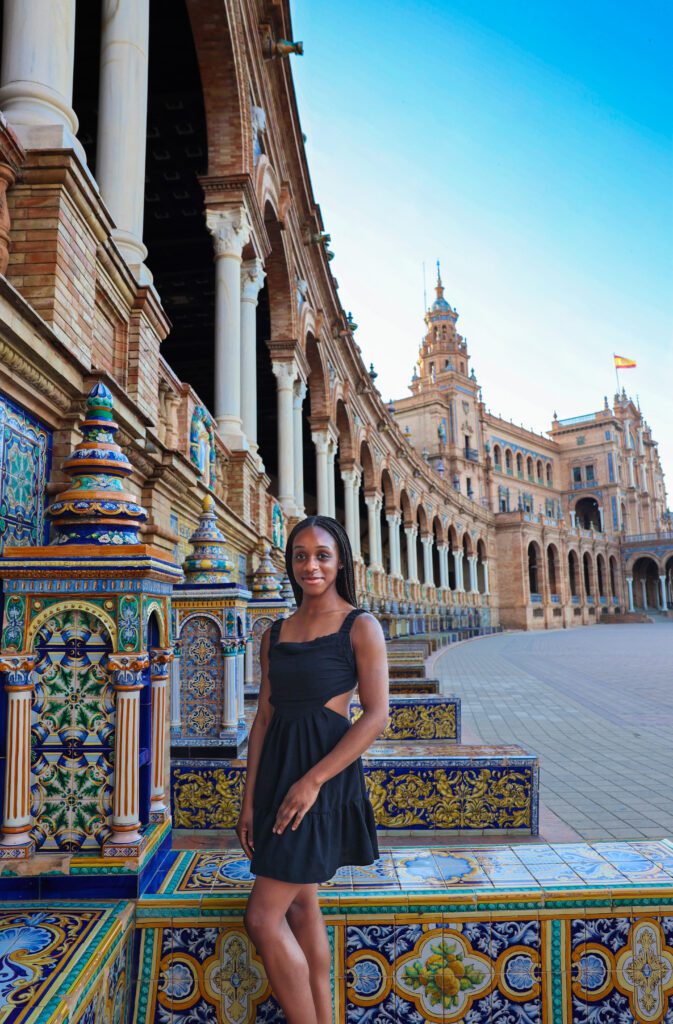 Girl enjoying a sunny day in Plaza de España, Seville, Spain, with the iconic semi-circular building