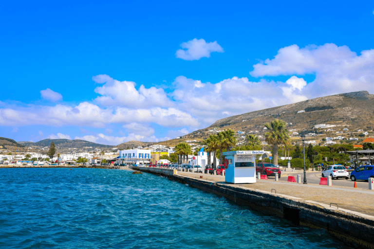 Scenic view of the picturesque port in Paros, Greece, with charming buildings, boats, and crystal-clear waters